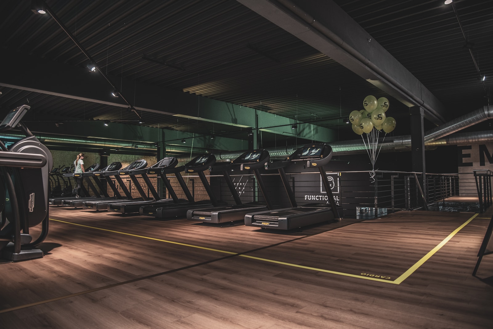 Image d’une salle de sport avec tapis roulants et autres équipements d’exercice.