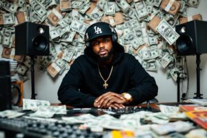 Homme en noir entouré de billets et d'équipement musical